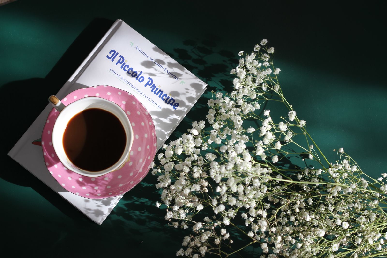Une tasse de café posée sur Il Piccolo Principe, l'édition italienne du Petit Prince
